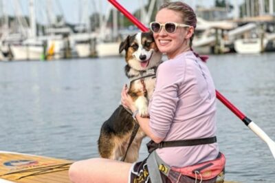 woman with dog on paddleboard